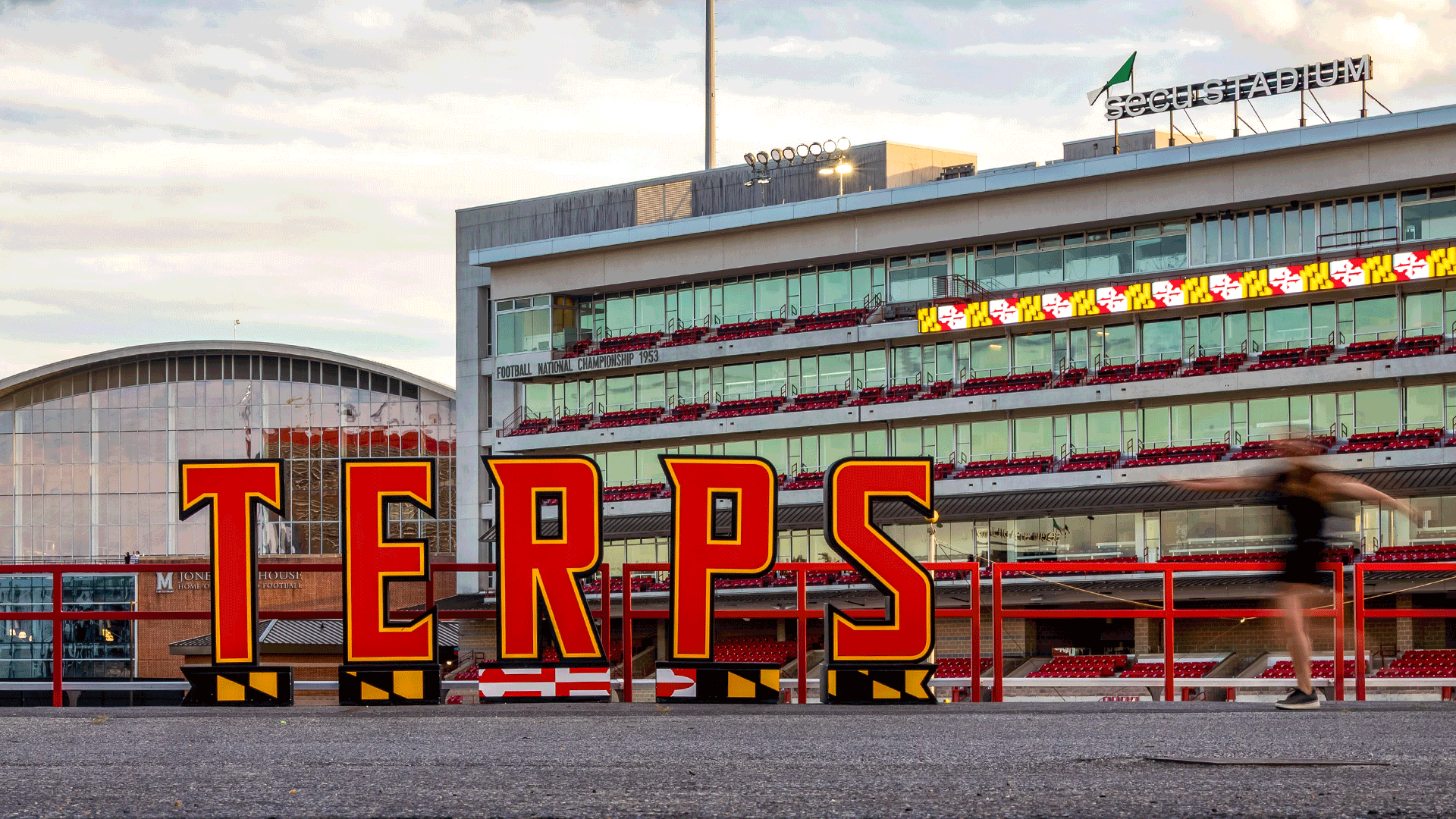 Animated photo of students walkin past TERPS sign outside SECU Stadium