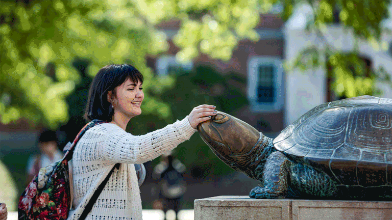 Gif of students rubbing Testudo statue's nose