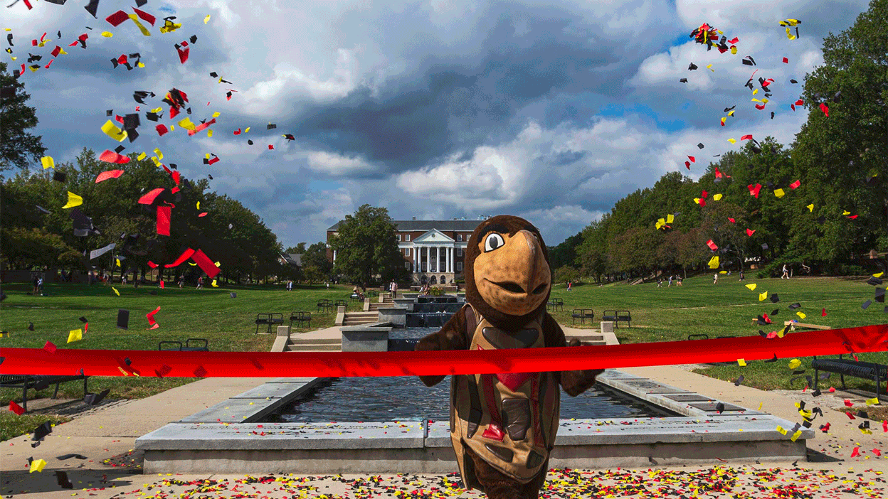 Testudo crossing finish line, surrounded by confetti