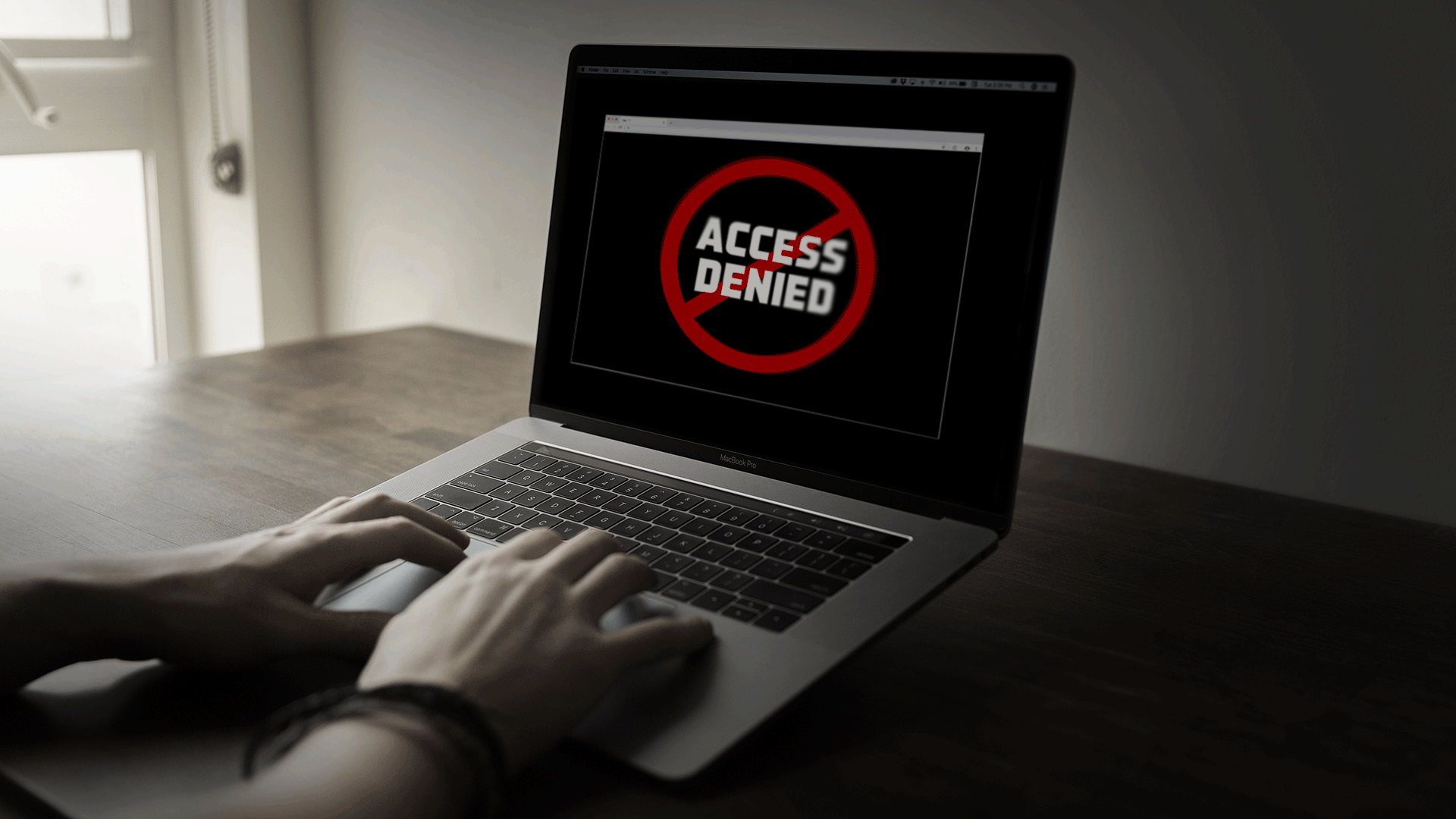 GIF of "Access Denied" message flashing on a laptop screen as hands type